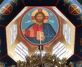 Interior view of a dome adorned with a painted photo of Christ.